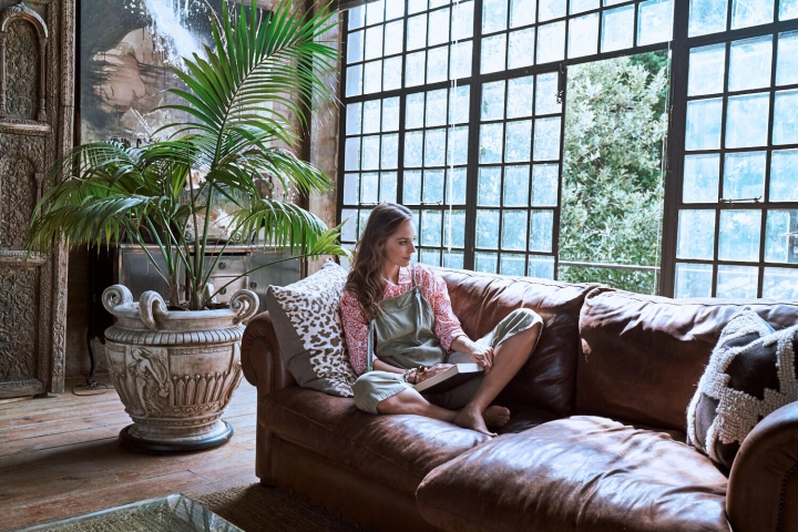 woman reading a book on the couch
